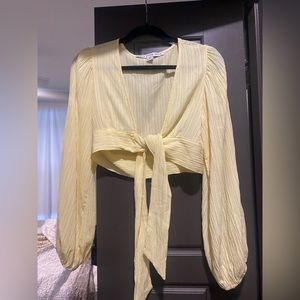 Light yellow crop top with tie in front.